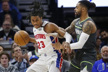 Dec 31, 2022; Minneapolis, Minnesota, USA; Detroit Pistons guard Jaden Ivey (23) works around Minnesota Timberwolves guard D'Angelo Russell (0) in the first quarter at Target Center. Mandatory Credit: Bruce Kluckhohn-USA TODAY Sports