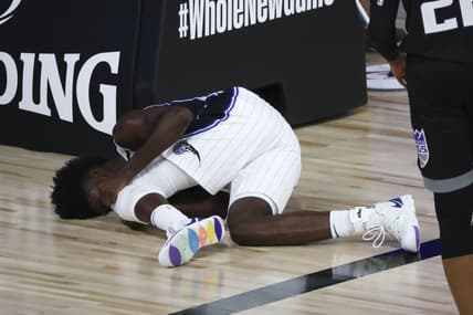 Aug 2, 2020; Lake Buena Vista, Florida, USA; Orlando Magic forward Jonathan Isaac (1) reacts after an injury against the Sacramento Kings in the second half of a NBA basketball game at HP Field House. Mandatory Credit: Kim Klement-USA TODAY Sports