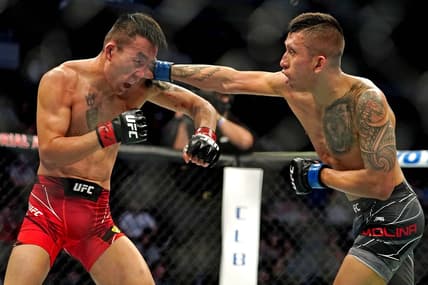 Apr 24, 2021; Jacksonville, Florida, USA; Aoriqileng (Red Gloves) fights Jeff Molina (Blue Gloves) during UFC 261 at VyStar Veterans Memorial Arena. Mandatory Credit: Jasen Vinlove-USA TODAY Sports