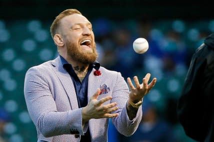Sep 21, 2021; Chicago, Illinois, USA; MMA fighter Conor McGregor tosses the ball after throwing out a ceremonial first pitch before the game between the Chicago Cubs and the Minnesota Twins at Wrigley Field. Mandatory Credit: Jon Durr-USA TODAY Sports