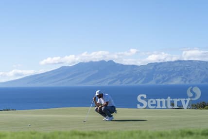 January 8, 2022; Maui, Hawaii, USA; Jon Rahm lines up his putt on the 10th hole during the third round of the Sentry Tournament of Champions golf tournament at Kapalua Resort - The Plantation Course. Mandatory Credit: Kyle Terada-USA TODAY Sports
