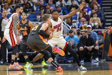 Apr 10, 2022; Orlando, Florida, USA; Miami Heat forward Haywood Highsmith (24) defends Orlando Magic center Moritz Wagner (21) during the first quarter at Amway Center. Mandatory Credit: Mike Watters-USA TODAY Sports