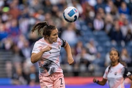 Jun 18, 2022; Seattle, Washington, USA; OL Reign midfielder Nikki Stanton (2) heads the ball against OL Reign at Lumen Field. Mandatory Credit: Stephen Brashear-USA TODAY Sports