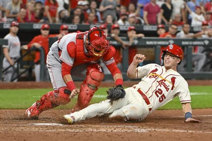 Sep 17, 2022; St. Louis, Missouri, USA;  St. Louis Cardinals left fielder Corey Dickerson (25) is tagged out at home by Cincinnati Reds catcher Austin Romine (28) during the tenth inning at Busch Stadium. Mandatory Credit: Jeff Curry-USA TODAY Sports