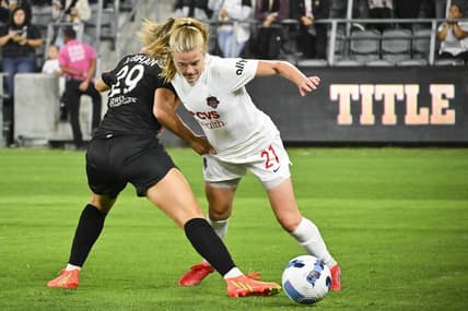 Sep 21, 2022; Los Angeles, California, USA; Washington Spirit midfielder Anna Heilferty (21) and Angel City FC midfielder Clarisse Le Bihan (29) battle for possession during the first half of a NWSL match at Banc of California Stadium. Mandatory Credit: Jayne Kamin-Oncea-USA TODAY Sports