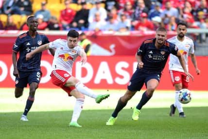 Oct 15, 2022; Harrison, New Jersey, USA;  New York Red Bulls midfielder Lewis Morgan (10) kicks the ball against FC Cincinnati midfielder Obinna Nwobodo (5) and defender Nick Hagglund (4) during the first half at Red Bull Arena. Mandatory Credit: Wendell Cruz-USA TODAY Sports