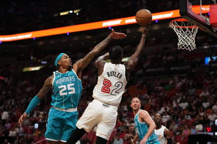 Nov 12, 2022; Miami, Florida, USA; Miami Heat forward Jimmy Butler (22) shoots the ball around Charlotte Hornets forward P.J. Washington (25) during the second half at FTX Arena. Mandatory Credit: Jasen Vinlove-USA TODAY Sports