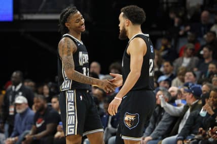 Dec 9, 2022; Memphis, Tennessee, USA; Memphis Grizzlies guard Ja Morant (12) and Memphis Grizzlies guard Tyus Jones (21) react during the second half against the Detroit Pistons at FedExForum. Mandatory Credit: Petre Thomas-USA TODAY Sports