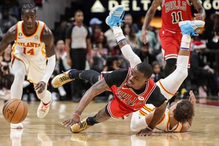 Dec 11, 2022; Atlanta, Georgia, USA; Chicago Bulls forward Javonte Green (24) and Atlanta Hawks guard Trae Young (11) fight for the ball on the floor during the second half at State Farm Arena. Mandatory Credit: Dale Zanine-USA TODAY Sports