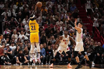 Dec 28, 2022; Miami, Florida, USA; Los Angeles Lakers guard Patrick Beverley (21) attempts a three point shot over Miami Heat guard Tyler Herro (14) during the second half at FTX Arena. Mandatory Credit: Jasen Vinlove-USA TODAY Sports