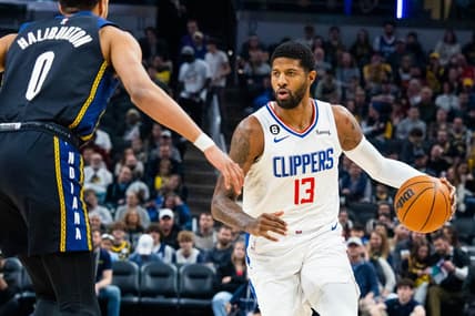 Dec 31, 2022; Indianapolis, Indiana, USA; LA Clippers guard Paul George (13) dribbles the ball while Indiana Pacers guard Tyrese Haliburton (0) defends in the first quarter at Gainbridge Fieldhouse. Mandatory Credit: Trevor Ruszkowski-USA TODAY Sports