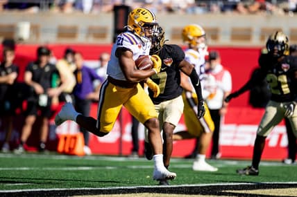 Jan 2, 2023; Orlando, FL, USA; LSU Tigers running back Noah Cain (21) rushes for a touchdown during the first half against the Purdue Boilermakers at Camping World Stadium. Mandatory Credit: Matt Pendleton-USA TODAY Sports