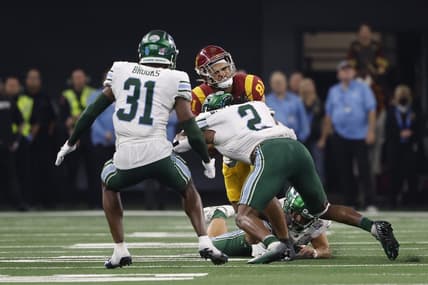 Jan 2, 2023; Arlington, Texas, USA; USC Trojans wide receiver Kyle Ford (81) is tackled by Tulane Green Wave linebacker Dorian Williams (2) in the second quarter in the 2023 Cotton Bowl at AT&T Stadium. Mandatory Credit: Tim Heitman-USA TODAY Sports