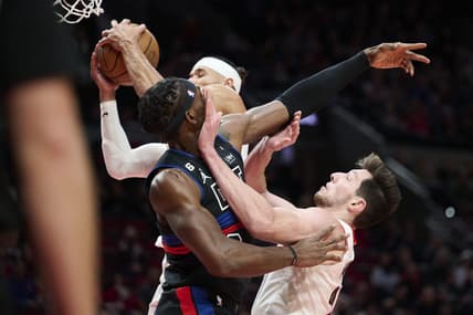 Jan 2, 2023; Portland, Oregon, USA; Detroit Pistons center Jalen Duren (0) fights for a rebound against Portland Trail Blazers forward Drew Eubanks (24) and guard Josh Hart (11) at Moda Center. Mandatory Credit: Troy Wayrynen-USA TODAY Sports