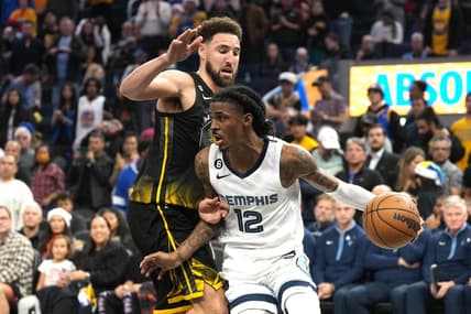 Dec 25, 2022; San Francisco, California, USA; Memphis Grizzlies guard Ja Morant (12) dribbles against Golden State Warriors guard Klay Thompson (11) during the fourth quarter at Chase Center. Mandatory Credit: Darren Yamashita-USA TODAY Sports
