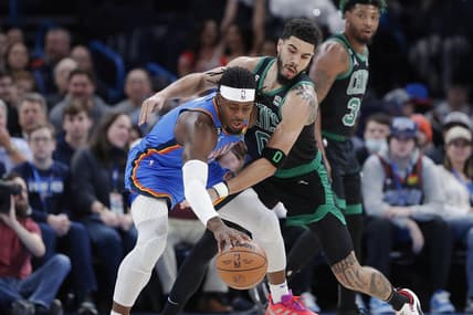 Jan 3, 2023; Oklahoma City, Oklahoma, USA; Oklahoma City Thunder guard Luguentz Dort (5) works to keep the ball away from Boston Celtics forward Jayson Tatum (0) during the first quarter at Paycom Center. Mandatory Credit: Alonzo Adams-USA TODAY Sports