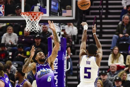 Jan 3, 2023; Salt Lake City, Utah, USA; Sacramento Kings guard De'Aaron Fox (5) shoots the ball over Utah Jazz guard Nickeil Alexander-Walker (6) during the fourth quarter at Vivint Arena. Mandatory Credit: Christopher Creveling-USA TODAY Sports