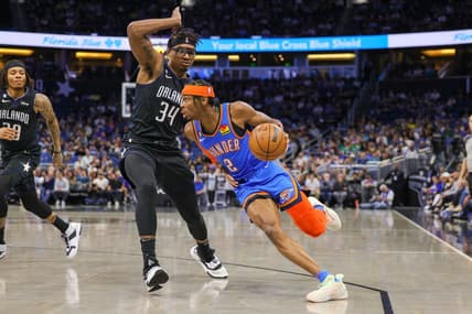 Jan 4, 2023; Orlando, Florida, USA; Oklahoma City Thunder guard Shai Gilgeous-Alexander (2) drives around Orlando Magic center Wendell Carter Jr. (34) during the first quarter at Amway Center. Mandatory Credit: Mike Watters-USA TODAY Sports