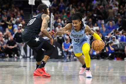 Jan 5, 2023; Orlando, Florida, USA;  Memphis Grizzlies guard Ja Morant (12) drives pat Orlando Magic guard Markelle Fultz (20) in the fourth quarter at Amway Center. Mandatory Credit: Nathan Ray Seebeck-USA TODAY Sports