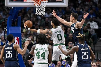 Jan 5, 2023; Dallas, Texas, USA; Boston Celtics forward Jayson Tatum (0) drives to the basket past Dallas Mavericks guard Spencer Dinwiddie (26) and forward Reggie Bullock (25) and center Dwight Powell (7) during the second half at the American Airlines Center. Mandatory Credit: Jerome Miron-USA TODAY Sports