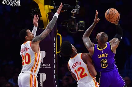 Jan 6, 2023; Los Angeles, California, USA; Los Angeles Lakers forward LeBron James (6) moves to the basket against Atlanta Hawks forward De'Andre Hunter (12) and forward John Collins (20) during the first half at Crypto.com Arena. Mandatory Credit: Gary A. Vasquez-USA TODAY Sports