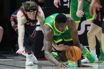 Jan 7, 2023; Salt Lake City, Utah, USA; Utah Utes center Branden Carlson (35) and Oregon Ducks center N'Faly Dante (1) dive for a loose ball in the first half at Jon M. Huntsman Center. Mandatory Credit: Rob Gray-USA TODAY Sports
