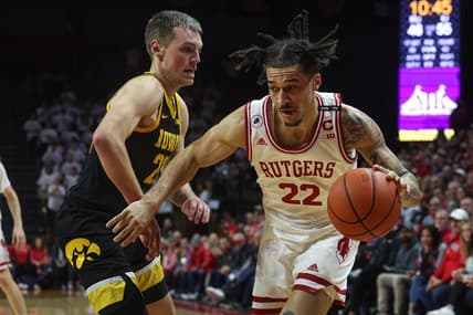 Jan 8, 2023; Piscataway, New Jersey, USA; Rutgers Scarlet Knights guard Caleb McConnell (22) dribbles against Iowa Hawkeyes forward Payton Sandfort (20) during the second half at Jersey Mike's Arena. Mandatory Credit: Vincent Carchietta-USA TODAY Sports