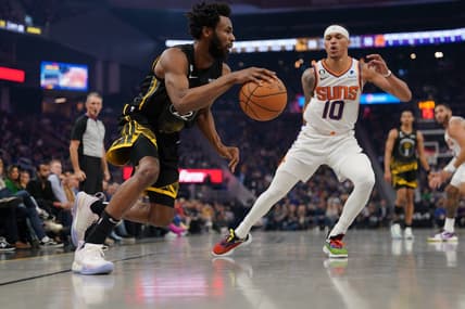 Jan 10, 2023; San Francisco, California, USA; Golden State Warriors forward Andrew Wiggins (22) dribbles past Phoenix Suns guard Damion Lee (10) in the second quarter at the Chase Center. Mandatory Credit: Cary Edmondson-USA TODAY Sports