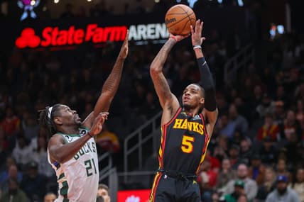 Jan 11, 2023; Atlanta, Georgia, USA; Atlanta Hawks guard Dejounte Murray (5) shoots over Milwaukee Bucks guard Jrue Holiday (21) in the first quarter at State Farm Arena. Mandatory Credit: Brett Davis-USA TODAY Sports
