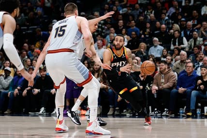 Jan 11, 2023; Denver, Colorado, USA; Phoenix Suns guard Duane Washington Jr. (4) controls the ball under pressure from Denver Nuggets forward Michael Porter Jr. (1) and center Nikola Jokic (15) in the first quarter at Ball Arena. Mandatory Credit: Isaiah J. Downing-USA TODAY Sports