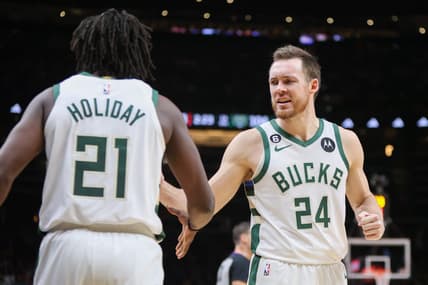 Jan 11, 2023; Atlanta, Georgia, USA; Milwaukee Bucks guard Pat Connaughton (24) reacts with guard Jrue Holiday (21) against the Atlanta Hawks in the second half at State Farm Arena. Mandatory Credit: Brett Davis-USA TODAY Sports