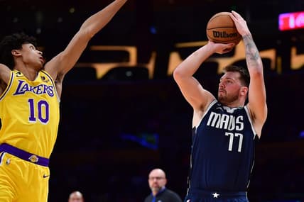 Jan 12, 2023; Los Angeles, California, USA; Dallas Mavericks guard Luka Doncic (77) shoots against Los Angeles Lakers guard Max Christie (10) during the first half at Crypto.com Arena. Mandatory Credit: Gary A. Vasquez-USA TODAY Sports