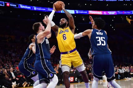 Jan 12, 2023; Los Angeles, California, USA; Los Angeles Lakers forward LeBron James (6) moves to the basket against Dallas Mavericks guard Luka Doncic (77) and forward Christian Wood (35) during the second half at Crypto.com Arena. Mandatory Credit: Gary A. Vasquez-USA TODAY Sports