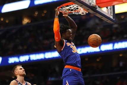 Jan 13, 2023; Washington, District of Columbia, USA; New York Knicks forward Julius Randle (30) dunks the ball as Washington Wizards center Kristaps Porzingis (6) looks on in the first quarter at Capital One Arena. Mandatory Credit: Geoff Burke-USA TODAY Sports