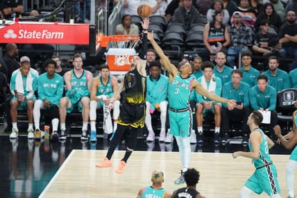 Jan 13, 2023; San Antonio, Texas, USA;  Golden State Warriors guard Donte DiVincenzo (0) shoots in front of San Antonio Spurs forward Keldon Johnson (3) in the second half at the Alamodome. Mandatory Credit: Daniel Dunn-USA TODAY Sports