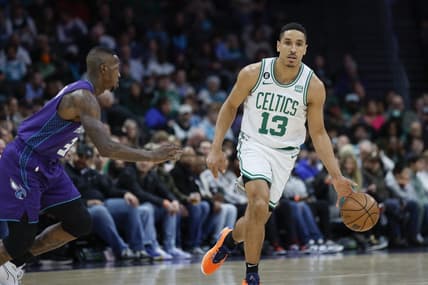 Jan 14, 2023; Charlotte, North Carolina, USA; Boston Celtics guard Malcolm Brogdon (13) controls the ball against Charlotte Hornets guard Terry Rozier (3) during the first half at Spectrum Center. Mandatory Credit: Nell Redmond-USA TODAY Sports