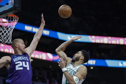 Jan 14, 2023; Charlotte, North Carolina, USA; Boston Celtics forward Jayson Tatum (0) shoots over Charlotte Hornets center Mason Plumlee (24) during the first half at Spectrum Center. Mandatory Credit: Nell Redmond-USA TODAY Sports