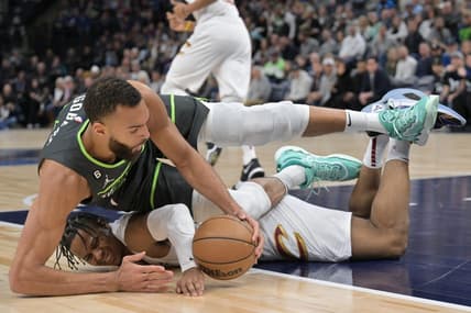 Jan 14, 2023; Minneapolis, Minnesota, USA; Minnesota Timberwolves center Rudy Gobert (27) and Cleveland Cavaliers forward Isaac Okoro (35) battle for a loose ball during the first quarter at Target Center. Mandatory Credit: Jeffrey Becker-USA TODAY Sports