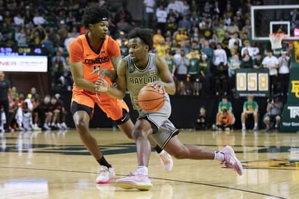 Jan 14, 2023; Waco, Texas, USA; Baylor Bears guard LJ Cryer (4) works past Oklahoma State Cowboys guard Woody Newton (4) during the second half at Ferrell Center. Mandatory Credit: Raymond Carlin III-USA TODAY Sports