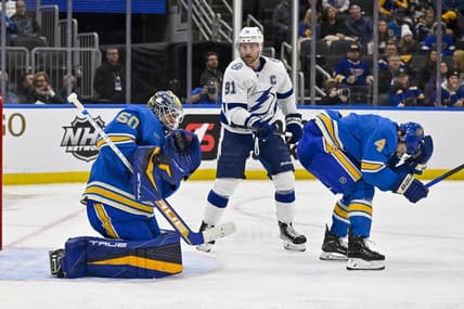 Jan 14, 2023; St. Louis, Missouri, USA;  St. Louis Blues goaltender Jordan Binnington (50) makes a save as defenseman Nick Leddy (4) defends against Tampa Bay Lightning center Steven Stamkos (91) during the third period at Enterprise Center. Mandatory Credit: Jeff Curry-USA TODAY Sports