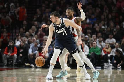 Jan 14, 2023; Portland, Oregon, USA; Dallas Mavericks guard Luka Doncic (77) dribbles the ball during the first half against Portland Trail Blazers guard Damian Lillard (0) at Moda Center. Mandatory Credit: Troy Wayrynen-USA TODAY Sports