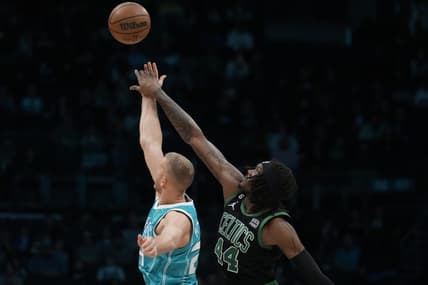 Jan 16, 2023; Charlotte, North Carolina, USA; Boston Celtics center Robert Williams III (44) gets the edge on the opening tip-off over Charlotte Hornets center Mason Plumlee (24) during the first quarter at Spectrum Center. Mandatory Credit: Jim Dedmon-USA TODAY Sports