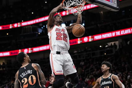 Jan 16, 2023; Atlanta, Georgia, USA; Miami Heat forward Jimmy Butler (22) dunks between Atlanta Hawks forwards John Collins (20) and  De'Andre Hunter (12) during the first half at State Farm Arena. Mandatory Credit: Dale Zanine-USA TODAY Sports