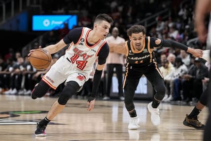 Jan 16, 2023; Atlanta, Georgia, USA; Miami Heat guard Tyler Herro (14) dribbles against Atlanta Hawks guard Trae Young (11) during the first half at State Farm Arena. Mandatory Credit: Dale Zanine-USA TODAY Sports