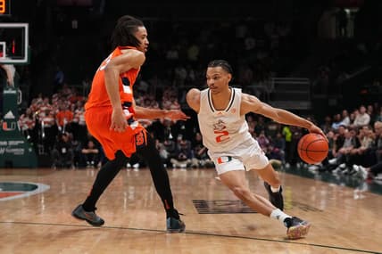 Jan 16, 2023; Coral Gables, Florida, USA; Miami Hurricanes guard Isaiah Wong (2) drives the ball around Syracuse Orange forward Benny Williams (13) during the second half at Watsco Center. Mandatory Credit: Jasen Vinlove-USA TODAY Sports