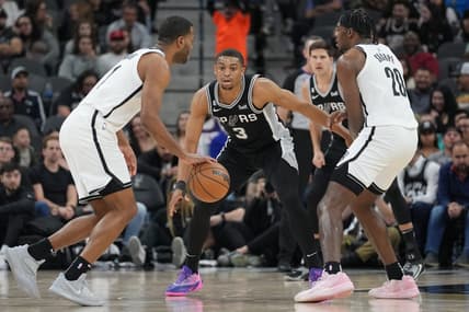 Jan 17, 2023; San Antonio, Texas, USA;  San Antonio Spurs forward Keldon Johnson (3) defends Brooklyn Nets forward T.J. Warren (1) in the first half at the AT&T Center. Mandatory Credit: Daniel Dunn-USA TODAY Sports