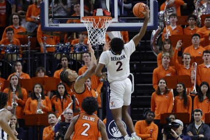 Jan 18, 2023; Charlottesville, Virginia, USA; Virginia Cavaliers guard Reece Beekman (2) dunks the ball as Virginia Tech Hokies center Lynn Kidd (15) defends in the first half at John Paul Jones Arena. Mandatory Credit: Geoff Burke-USA TODAY Sports