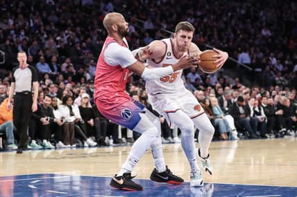 Jan 18, 2023; New York, New York, USA; New York Knicks center Isaiah Hartenstein (55) looks to post up against Washington Wizards forward Taj Gibson (67) in the second quarter at Madison Square Garden. Mandatory Credit: Wendell Cruz-USA TODAY Sports