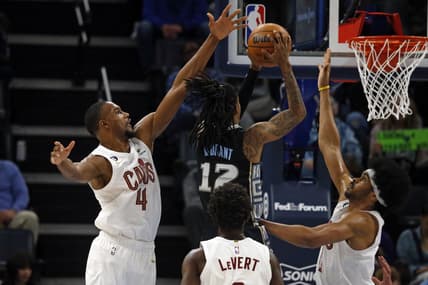Jan 18, 2023; Memphis, Tennessee, USA; Cleveland Cavaliers forward Evan Mobley (4) and Cleveland Cavaliers center Jarrett Allen (31) defend as Memphis Grizzlies guard Ja Morant (12) drives to the basket during the first half at FedExForum. Mandatory Credit: Petre Thomas-USA TODAY Sports