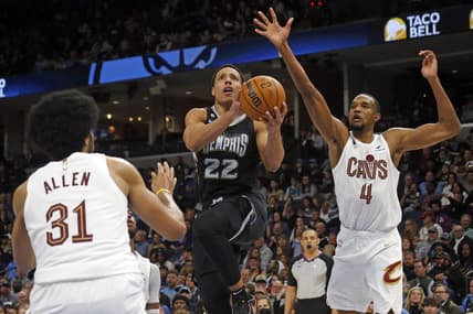 Jan 18, 2023; Memphis, Tennessee, USA; Memphis Grizzlies guard Desmond Bane (22) drives to the basket as Cleveland Cavaliers center Jarrett Allen (31) and forward Evan Mobley (4) defend during the second half at FedExForum. Mandatory Credit: Petre Thomas-USA TODAY Sports